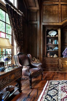 a bedroom with wood paneling and furniture in the corner, along with a large rug on the floor