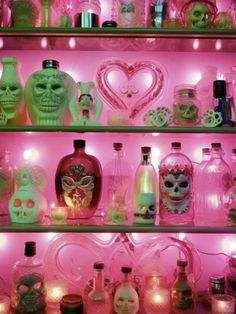 a shelf filled with lots of different types of booze bottles and skulls on it