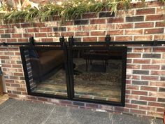 a brick fireplace with sliding glass doors on it