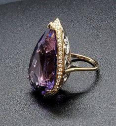 14k solid yellow & white gold ring with 0.60 ct. SI1, G color natural brilliant diamonds & 19.20 ct. 26x15 mm pear shape natural AAA amethyst. This item can also be ordered in white, rose or any other color gold combination with different color gemstones such as, blue topaz, London blue topaz, green amethyst, pink amethyst, citrine, garnet, smoky quartz, white topaz, aquamarine, peridot & morganite. Please contact me for a quote as each gemstone varies in price. Please don't hesitate Formal Teardrop Amethyst Ring In Fine Jewelry Style, Elegant Teardrop Amethyst Ring For Formal Occasions, Formal Teardrop Amethyst Ring, Formal Pear-shaped Amethyst Ring With Prong Setting, Elegant Formal Pear-shaped Amethyst Ring, Elegant Pear-shaped Amethyst Ring For Formal Occasions, Elegant Pear-shaped Amethyst Ring, Pear-shaped Amethyst Jewelry In Yellow Gold, Luxury Gold Multi-stone Amethyst Ring