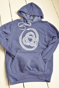 This super soft sponge fleece pullover hoodie is hand printed with our original Ouroboros design in our home studio on the Coast of Maine. It features kangaroo pockets, ribbed cuffs and waistband, has a hood drawstring and is pre-shrunk. Details: * Original Hearth and Harrow Snake design, printed in white * Bella + Canvas Sponge Fleece Hoodie in navy/grey * Eco-friendly, water-based ink * Unisex sizing * Machine wash cold, tumble dry The handmade quality of our products assures that each one is Casual Fleece Hoodie With Screen Print, Long Sleeve Fleece Hoodie With Screen Print, Ouroboros Design, Snake Hoodie, Snake Design, Navy Grey, Print Pullover, Fleece Hoodie, Bella Canvas