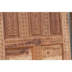 an intricately carved wooden door with carvings on it