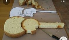 bread cut into pieces on top of a cutting board with knifes and knives next to it