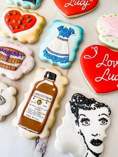 decorated cookies are arranged on a table with the words i love lucy written above them