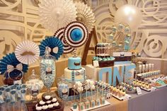 a dessert table with blue and white decorations