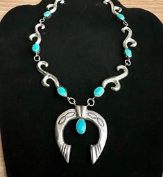 This pretty much loved Navaho Naja necklace was purchased by my mother in 1962 on an Indian Reservation in Arizona.  It was her pride and joy. The necklace is 25 inches long.  The length is adjustable and has a hook and eye closure.  It features a beautiful 1.5 inch wide Naja.  The seven 8x10mm oval turquoise stones are perfectly matched and are a beautiful clear shade of blue.  The necklace is solid silver and the stones are genuine and unaltered.  The hand made necklace weighs 58 grams. This n Turquoise Spiritual Jewelry For Anniversary, Spiritual Turquoise Jewelry For Anniversary, Turquoise Spiritual Jewelry With Inlay, Collectible Teardrop Turquoise Jewelry, Spiritual Turquoise Jewelry With Inlay, One Of A Kind Turquoise Jewelry For Anniversary, Vintage Blue Turquoise Necklace, Spiritual Hallmarked Turquoise Jewelry, Spiritual Turquoise Jewelry With Hallmark