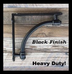 a black finish heavy duty hook on a wooden wall with the words, black finish heavy duty