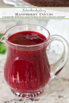 a glass pitcher filled with raspberry couliure