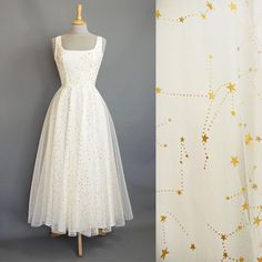 Our star gazer dress is made from layers of soft floaty tulle which features a metallic gold celestial pattern that shimmers in the light. The square scoop bodice and ballerina length circle skirt offer an understated nod to the 1950s while maintaining the flattering shape that our customers love. The tulle is overlaid on to a cotton poplin base for a dress that is light and comfortable to wear all day. Fastening at the back with a concealed zip, the dress is fully lined with cotton on the bodic Wedding Dress Ankle Length, Celestial Wedding Dress, Dig For Victory, Dress Ankle Length, Celestial Pattern, Above Elbow, Celestial Wedding, Bra Types, Long Torso