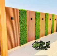 a row of wooden fences covered in green plants