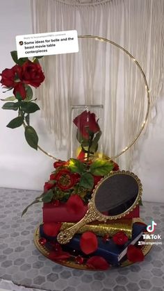 there is a red rose in the middle of a cake with a mirror on it