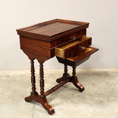 an antique wooden desk with drawers on it