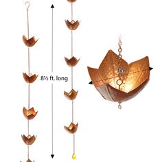 an origami lantern is hanging from chains and has eight smaller ones attached to it