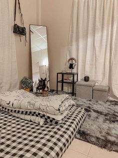 a black and white checkered bedspread in front of a large mirror on the wall