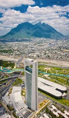 an aerial view of a city with mountains in the background