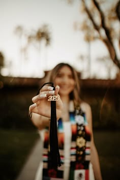 a woman is holding up her name ring