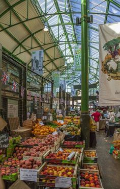 an outdoor market with lots of fruits and vegetables