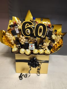 a 50th birthday gift box filled with chocolates, candy and liquor bottles in it