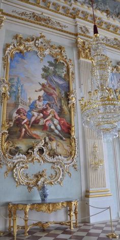 an ornately decorated room with paintings and chandeliers