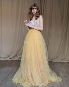 This a fancy tulle wedding skirt with a long train, elegant and airy. The skirt consists of several layers of mustard silk, pale gold chiffon, and marigold tulle. It is fastened on the back with a concealed zipper. If you want to change any detail in the style of the wedding skirt, just email us. We will discuss everything and make a custom skirt for you. All our skirt are made to order, so please allow 1 - 2 weeks for production. This time rate doesn't include the shipping time. Rush orders: Pl Yellow Ball Gown For Wedding, Elegant Yellow Gown For Debutante Ball, Yellow Tulle Wedding Gown, Yellow Floor-length Evening Dress For Wedding, Yellow Tulle Gown For Wedding, Elegant Long Yellow Skirt, Yellow Long Skirt For Evening, Elegant Flowy Yellow Skirt, Elegant Yellow Flowy Skirt