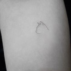 a small horse head tattoo on the left thigh