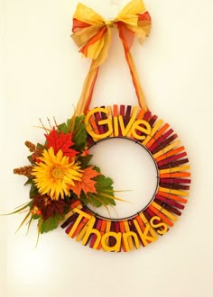 a wreath with the words give thanks written on it