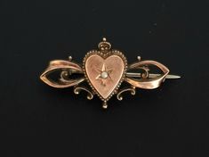 This delightful antique brooch is a wonderful example of Art Nouveau style (Germany Jugendstil) turn of the 19th and 20th centuries.  The brooch is made in a typical Art Nouveau heart shaped design. The front side is gold plated  and decorated with a small pearl in the middle. This is a very gentle and touching brooch that evokes a slight nostalgic sadness for bygone times.  This brooch can be a wonderful gift for a connoisseur of antique jewelry or an excellent acquisition for collectors.  The Victorian Brooches For Vintage Events, Victorian Filigree Brooches For Vintage Events, Vintage Brooches With Intricate Design For Ceremonial Use, Antique Wedding Brooches, Victorian Style Bronze Brooches For Formal Occasions, Victorian Style Formal Brooches, Antique Gold Brooch For Gift, Victorian Bronze Brooch For Formal Occasions, Victorian Brooch Pins For Wedding