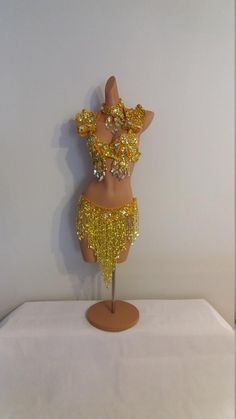 a mannequin with gold sequins on it