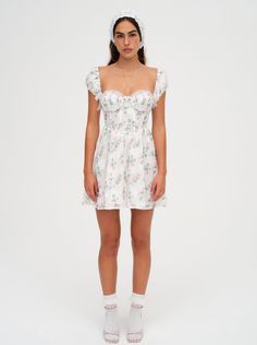 The Remi floral mini dress makes us want to go flower picking. Crafted in a rose-printed burnout fabric, this white sundress has elegant scrunchie cap sleeves, a fitted bodice with ruched cups, and is finished with an intricate lace trim along the neckline. For Love And Lemons Heart Dress, For Love And Lemons Samira Mini Dress, For Love And Lemons Sorbet Dress, For Love And Lemons Dress White, For Love And Lemons Floral Dress, Burnout Fabric, White Sundress, Sleepwear Dress, Tanya Taylor