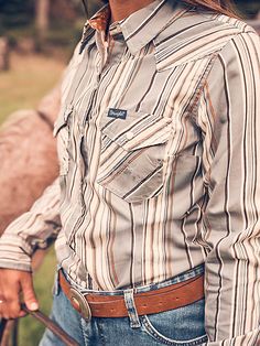 MADE TO WEAR EVERYWHERE A cowgirl can never have too many collared shirts for competition and daily life. Our Women's Wrangler Retro® All-Occasion Western Snap Dress Shirt is crafted a lightweight cotton and recycled materials blend that will keep you comfortable in everything you do. It comes with pointed yokes, pearl snaps, two chest pockets with the signature "W" stitching, and a contrast print at the cuffs. Western Style Button-up Ranch Shirt, Western Style Button-up Shirt For Ranch, Country Style Cotton Shirt For Rodeo, Western Button-up Tops For Rodeo, Country Style Long Sleeve Shirt For Ranch, Western Collared Tops For Ranch, Western Style Collared Tops For Ranch, Fitted Western Shirt For Western-themed Events, Western Style Button-up Top For Western-themed Events