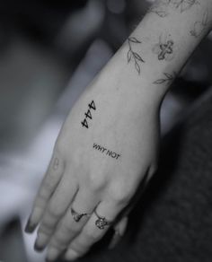 a woman's hand with a tattoo on it that says, why not?