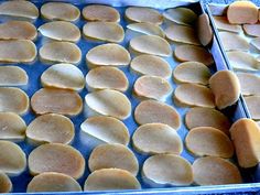 two pans filled with food sitting on top of a blue tablecloth next to each other