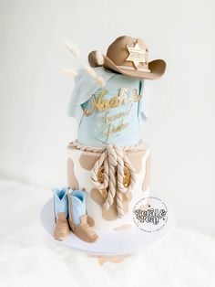 a birthday cake with cowboy hats and boots on top