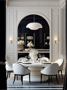 an elegant dining room with black and white walls, round table set for four people