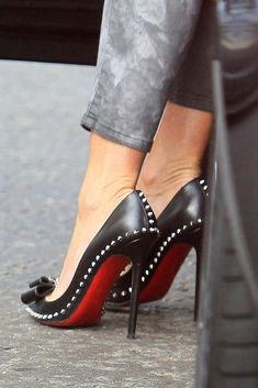 a woman's feet in high heels on the ground