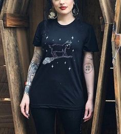 Attend your next witch's sabbath in this super soft unisex fashion tee.  Based off of the best-selling pin, this design features a baby goat learning to ride a broomstick.  -------------------------------------------------------------- Item Notes Small-2XL: Bella + Canvas - Unisex Viscose Fashion Tee 3-4XL: Bella + Canvas - Unisex CVC Jersey Tee Cotton Witchy Short Sleeve T-shirt, Witchy Cotton Short Sleeve T-shirt, Witchy Cotton Short Sleeve Tops, Witchy Short Sleeve Cotton T-shirt, Witchy Short Sleeve T-shirt With Graphic Print, Cotton Short Sleeve Witchy T-shirt, Witchy Short Sleeve Cotton Tops, Black Phillip, Baby Goat