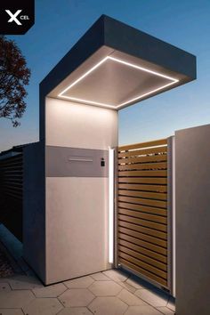 the entrance to a modern house with wooden slats and lights on it's sides