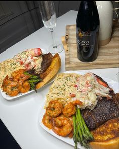 two plates of food and wine on a table