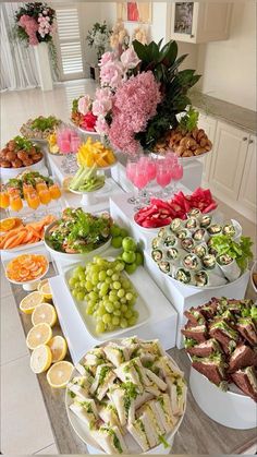 a table filled with lots of different types of food on plates and bowls next to each other