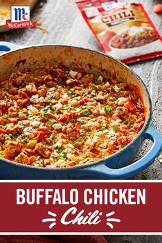 a blue pot filled with buffalo chicken chili next to a bag of macaroni and cheese