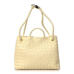 This is an authentic BOTTEGA VENETA Nappa Intrecciato Medium Andiamo Shoulder Bag in Chamomile. This stylish bag is crafted of light yellow nappa leather with Bottega Veneta's signature woven detailing. The bag features a rolled leather top handle, and a longer woven leather strap that can be worn as a crossbody or shoulder bag with an aged gold knot shaped clasp to remove the strap. The top opens to a leather interior with a pouch connected to the removable strap with a zipper compartment and p Classic Tote Bag With Intrecciato Weave, Classic Intrecciato Shoulder Bag For Shopping, Classic Intrecciato Weave Shoulder Bag For Shopping, Elegant Handheld Bag With Intrecciato Weave, Classic Intrecciato Weave Shoulder Bag, Designer Natural Bag With Intrecciato Weave, Elegant Bags With Intrecciato Weave For Daily Use, Classic Woven Leather Shopping Bags, Classic Woven Leather Shoulder Bag For Shopping