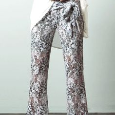 Ryu Floral Grey Lace Pants With Pops Of White And Turqoise, Sheer Lace Over Long Shorts. Elastic Waisband. Quantity: 4 Sizes Available: S, M, L Material Content: Lining - 100% Polyester, Lace Overlay - 90% Polyester, 10% Spandex Made In: China Bohemian Style High Waist White Wide Leg Pants, Casual White Party Pants, Casual White Pants For Party, White Bohemian Bottoms For Party, Bohemian Long Pants For Party, Bohemian Style White High Waist Wide Leg Pants, Party Floral Print Wide Leg Pants, White Bohemian Wide Leg Pants For Spring, Casual White Wide Leg Pants For Party