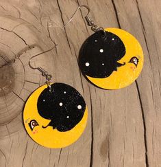 These novelty earrings are approximately 1.5 inches in diameter. Hand drawn and painted by Jeanine Each pair is one of a kind Hand Painted Yellow Artsy Earrings, Yellow Hand Painted Artsy Earrings, Artistic Hand Painted Yellow Earrings, Handmade Whimsical Moon Earrings, Whimsical Moon-shaped Handmade Earrings, Cute Hand Painted Dangle Earrings, Cute Hand Painted Drop Earrings, Quirky Handmade Black Earrings, Quirky Handmade Yellow Earrings