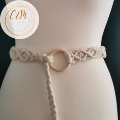 a close up of a person wearing a white belt with a knot on the side