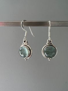 Sterling silver aquamarine dangle earrings . Beautiful Aquamarine stones set in sterling silver. All stones are natural and therefore each one is unique. Aquamarine is a healing stone, a stone of courage used for reducing stress and calming the mind. Promotes self expression and increases sensitivity and highly protective during pregnancy. Boosts the immune system and a great meditation stone. Birthstone of March. Gift box available for purchase. Search GIFTBOX Silver Aquamarine Dangle Earrings, Silver Aquamarine Gemstone Earrings, Silver Aquamarine Jewelry Set With Earrings, Handmade Blue Topaz Dangle Earrings, Handmade Aquamarine Dangle Earrings, Silver Aquamarine Round Earrings, Aquamarine Matching Earrings Jewelry, Aquamarine Round Jewelry With Matching Earrings, Silver Green Amethyst Earrings For Gift