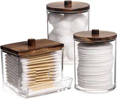 two clear containers with wooden lids and white plates