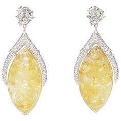 Exhibiting an attention to detail and craft, Ri Noor's Carved Citrine Earrings showcase a stunning display of gemstones that sparkle in the light. The earrings mix shapes and materials in a unique way which makes a special statement that elevates any outfit, no matter the occasion. Anchored by hand-carved ellipse-shaped citrine stones wrapped at the top by diamond-encrusted white gold shapes, the earrings meet the ear with abstract clusters of baguette and round brilliant diamonds. The almost 70 Carved Jewelry, Dangler Earrings, Citrine Jewelry, Citrine Earrings, Citrine Beads, Stone Wrapping, Earrings Geometric, Citrine Stone, Diamond Drops