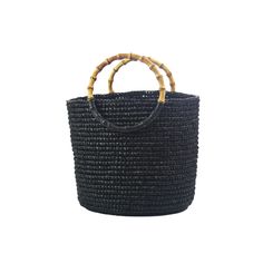 Medium Tote Woven Straw Solid with Bamboo Handle 100% Toquilla straw with Bamboo handle. This material is known for it's quality and beauty. Each bag is entirely hand made, since the straw dye to the weaving of the bag and strap. This chic and comfy bag is designed to carry all your essentials, while exuding quality and beauty. Perfectly designed for both fashion and function, this tote effortlessly combines rustic charm with sophisticated elegance. Elevate your wardrobe with this exclusive bag. Eco-friendly Black Bucket Bag With Leather Handles, Black Rectangular Straw Bag With Bamboo Handle, Rectangular Black Straw Bag With Woven Leather, Black Rectangular Straw Bag With Woven Leather, Black Bucket Straw Bag, Black Straw Bag With Round Handle For Everyday Use, Black Straw Tote Bag With Bamboo Handle, Black Straw Bag With Bamboo Handle For Travel, Black Straw Bag With Bamboo Handle For Daily Use