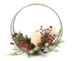 a candle and some pine cones are in a circle with red berries on the side