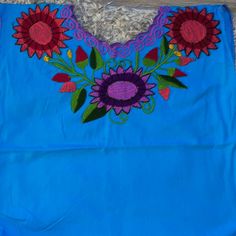 Mexican Top Embroidered Blusa Mexicana Blue Blue Embroidered Cotton Tops, Blue Cotton Top With Floral Embroidery, Blue Floral Embroidery Top For Vacation, Blue Floral Embroidery Beach Tops, Light Blue Floral Embroidery Tops For Vacation, Blue Embroidered Top For Summer Beach, Blue Bohemian Embroidered Top For Vacation, Blue Embroidered Top For Vacation, Blue Cotton Embroidered Short Sleeve Top